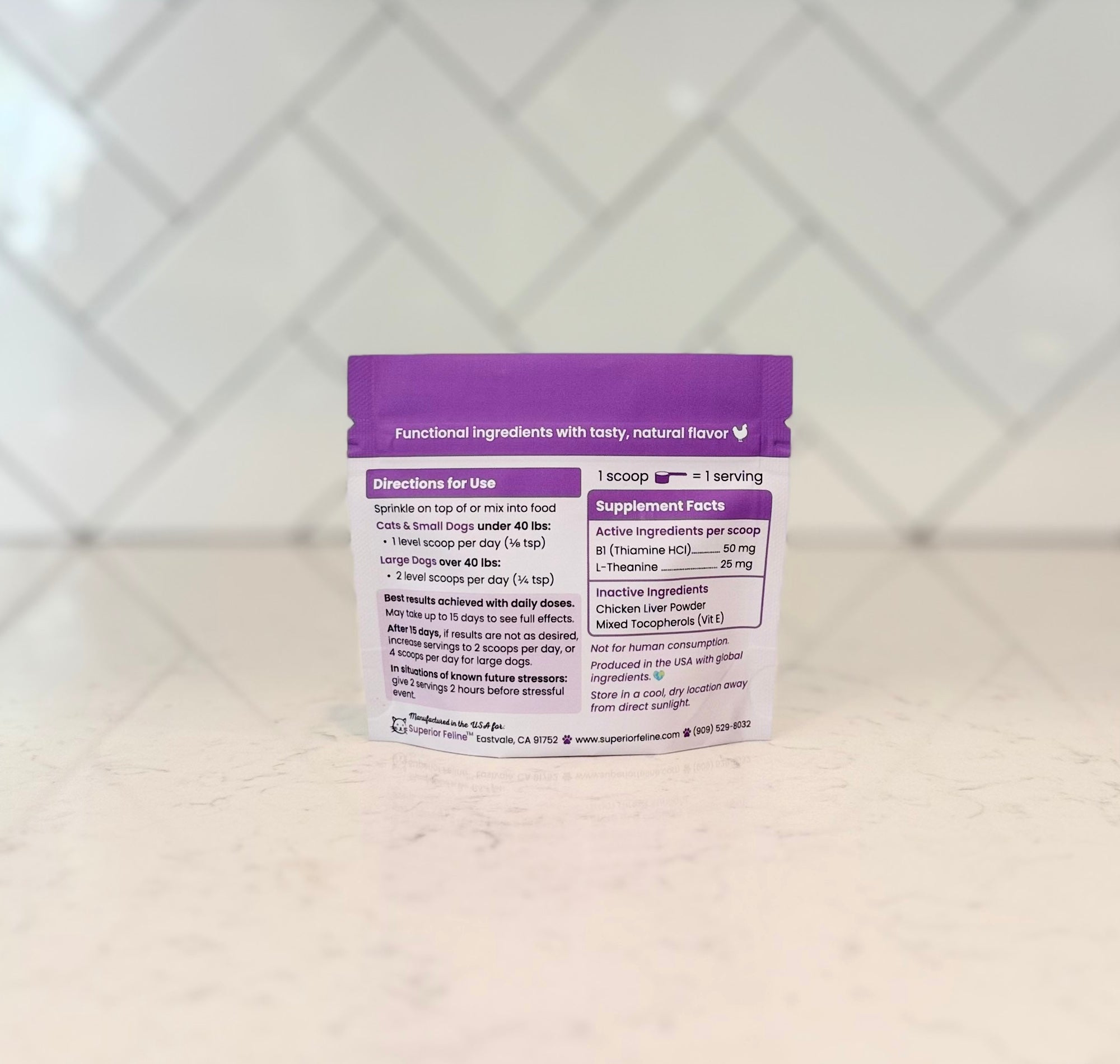 Back side of Superior Feline Calm package with text about directions and supplement facts on a countertop with a tiled backsplash