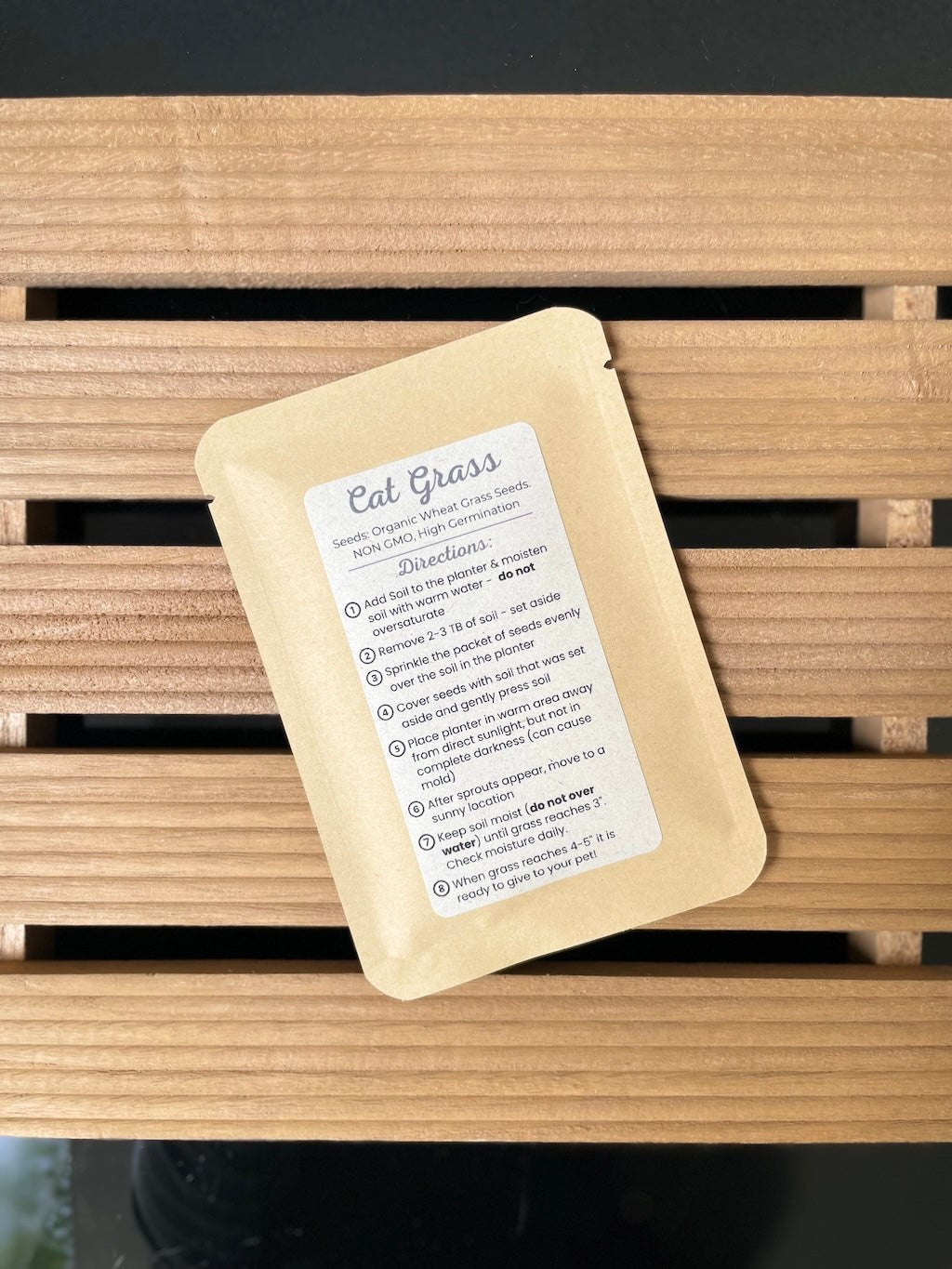 Cat grass packet on a wooden surface