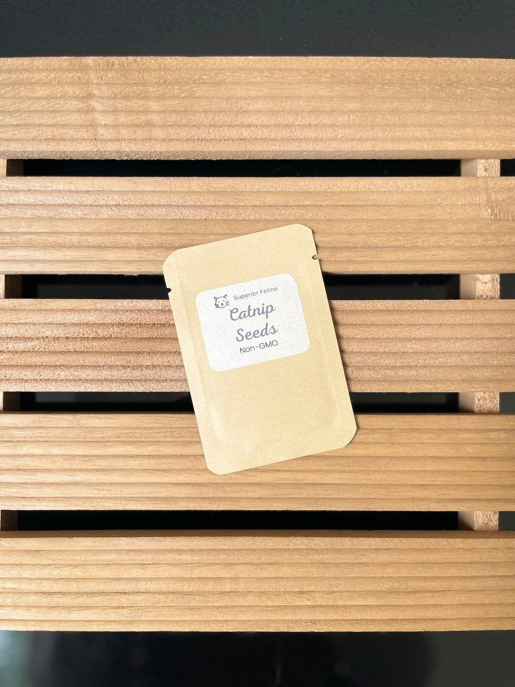 Small brown paper bag with a label on a wooden surface