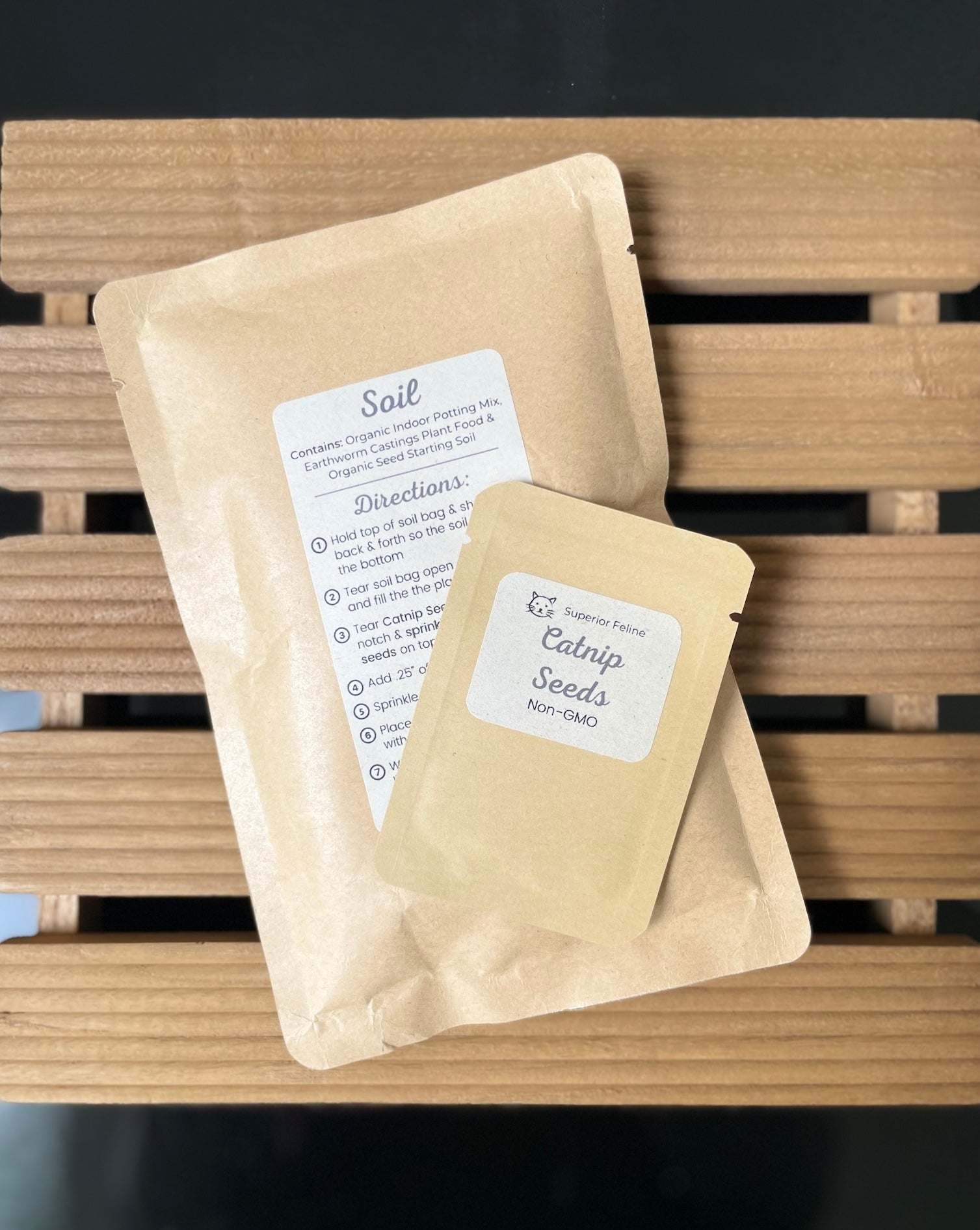 Two brown paper bags with labels on a wooden surface
