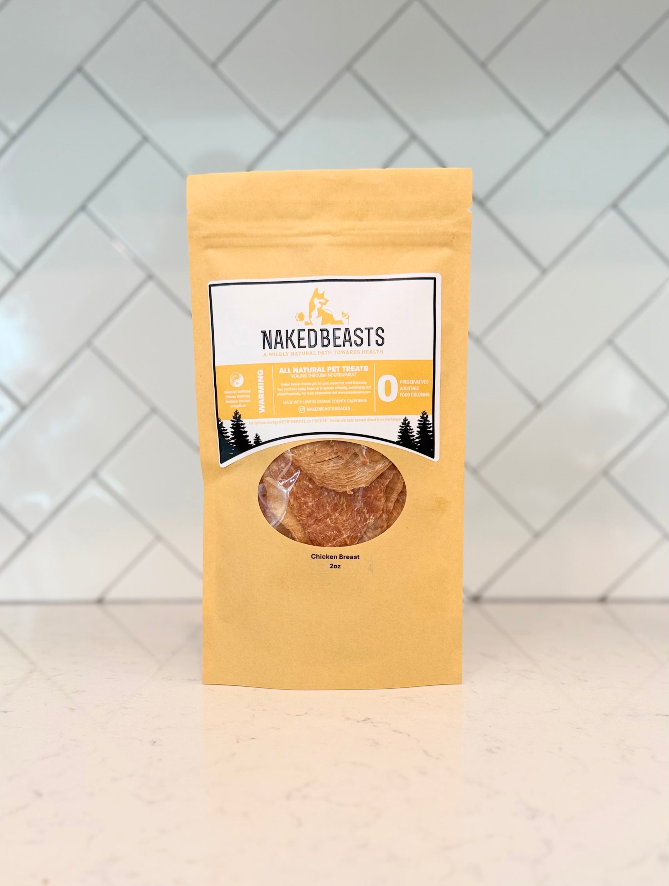 Package of Naked Beasts Chicken Breast Pet Snacks on a white surface with a tiled wall background