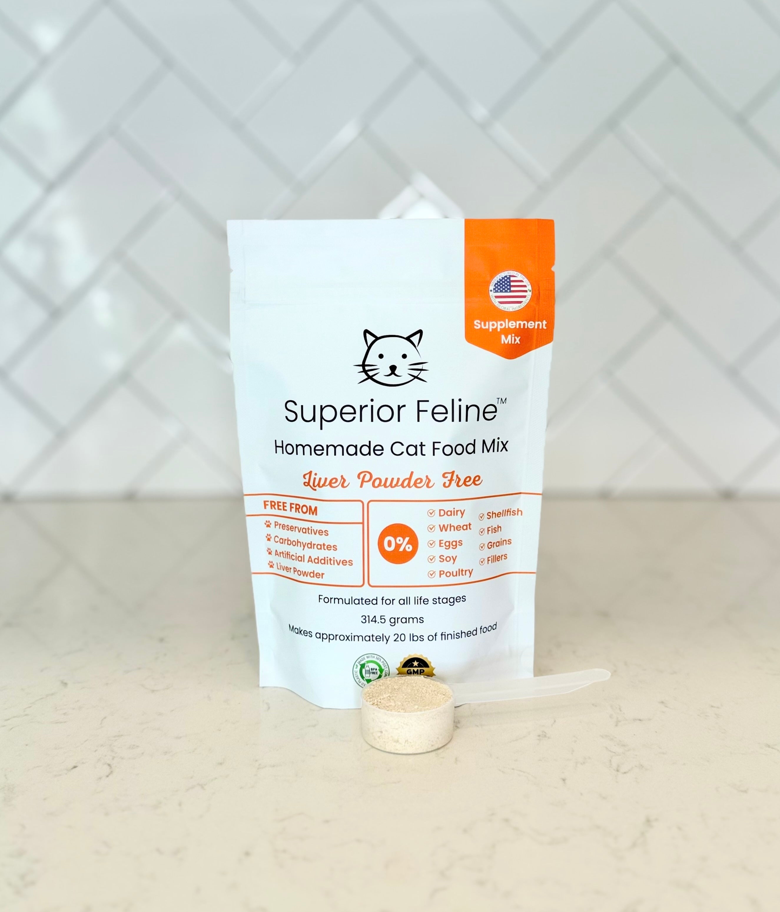 Front view of Superior Feline Liver Powder Free Homemade Cat Food Supplement Mix package with a scoop containing the powdered product sitting in front of it on a kitchen countertop with tiled backsplash