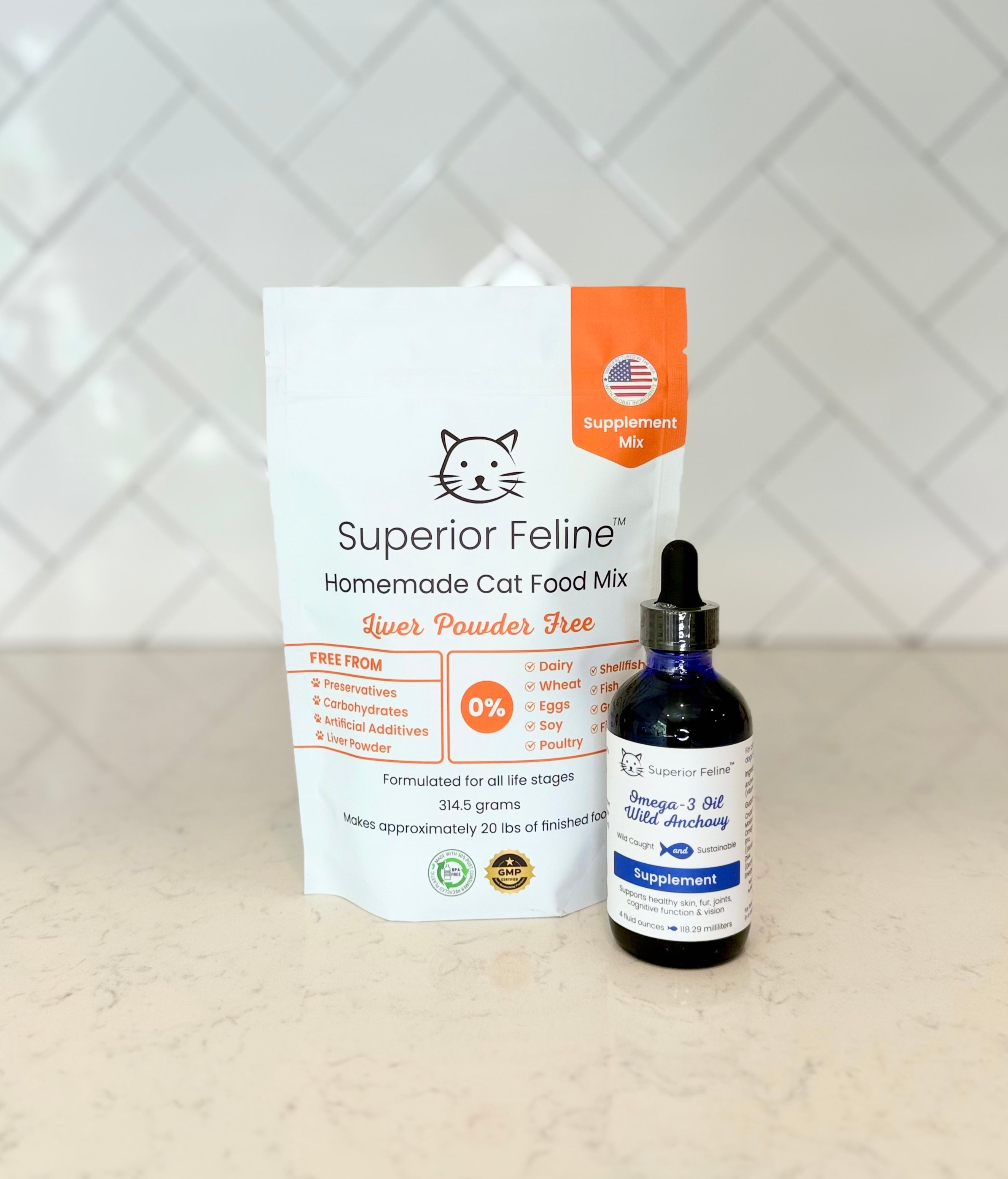 Superior Feline cat food mix package and a bottle of Wild Anchovy Omega-3 Oil supplement on a light surface with a white tiled background.