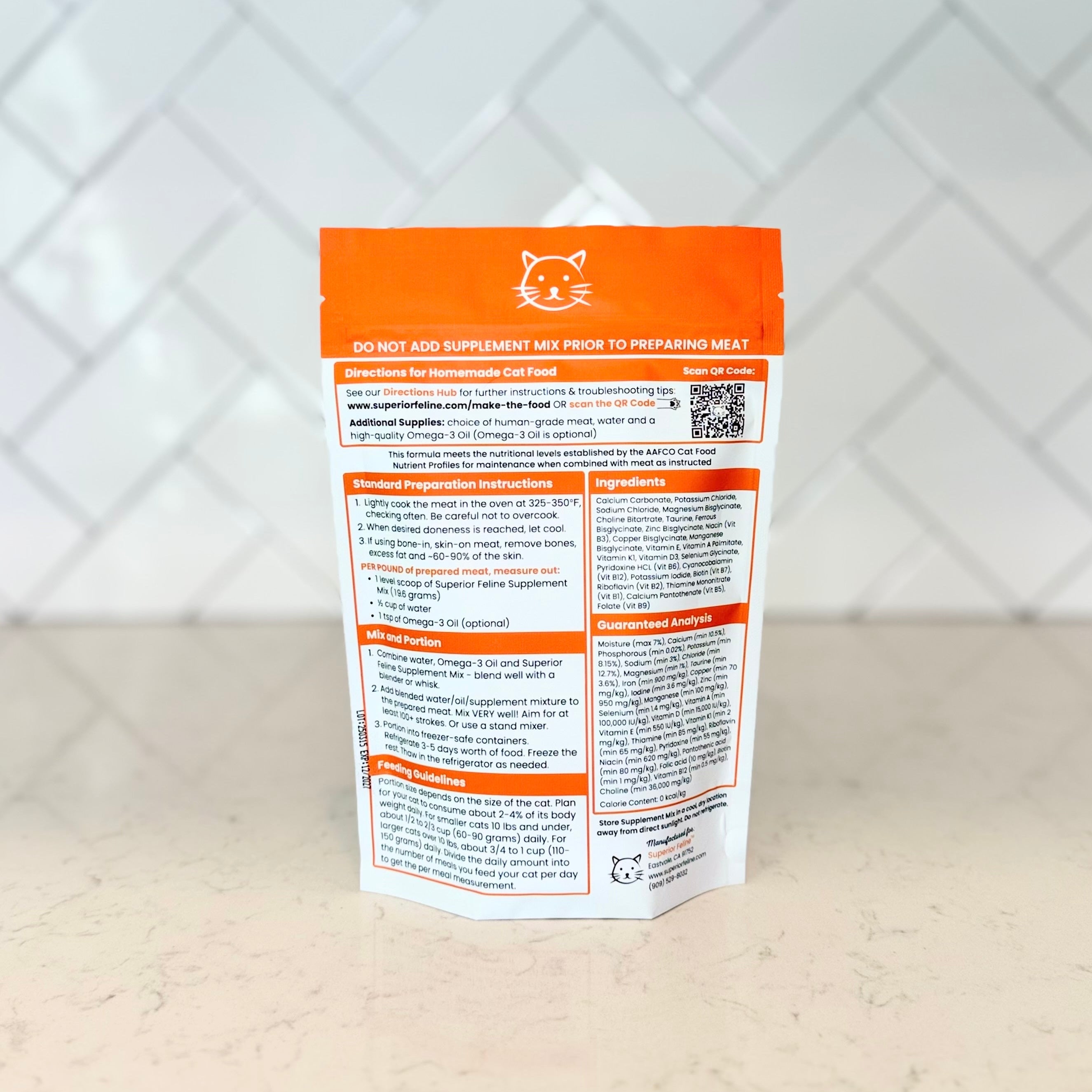 Back side of homemade cat food supplement mix with ingredient and directions on a white surface and tiled wall background