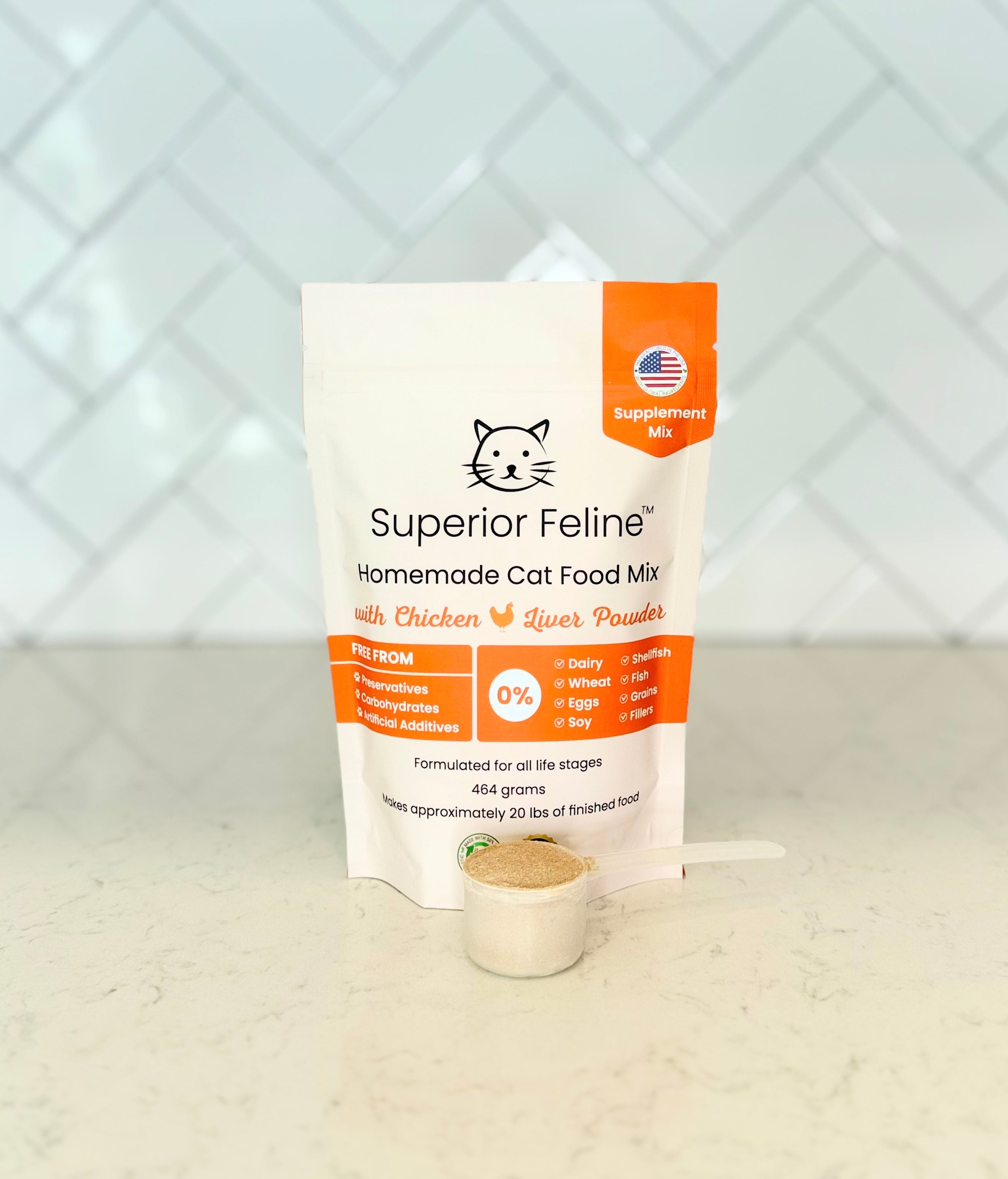 Front view of Superior Feline Original Formula Homemade Cat Food Supplement Mix package with a scoop containing the powdered product sitting in front of it on a kitchen countertop with tiled backsplash