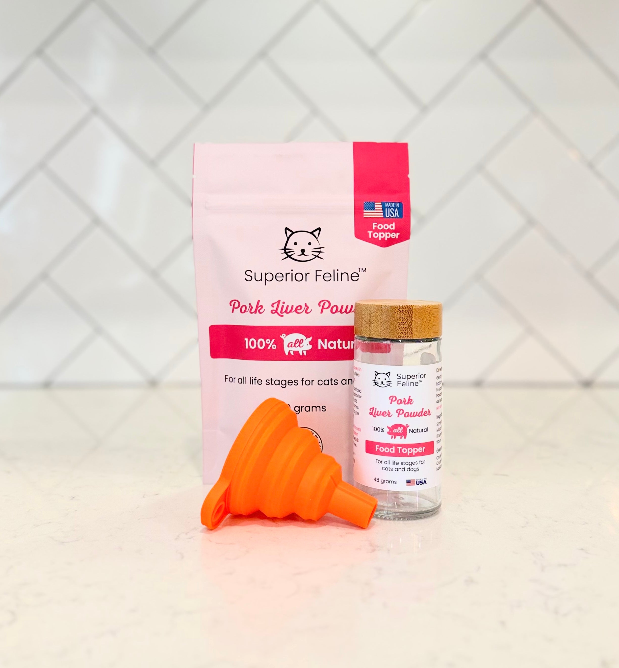 Superior Feline pork liver powder pouch with shaker jar and easy-fill orange funnel on a tiled background