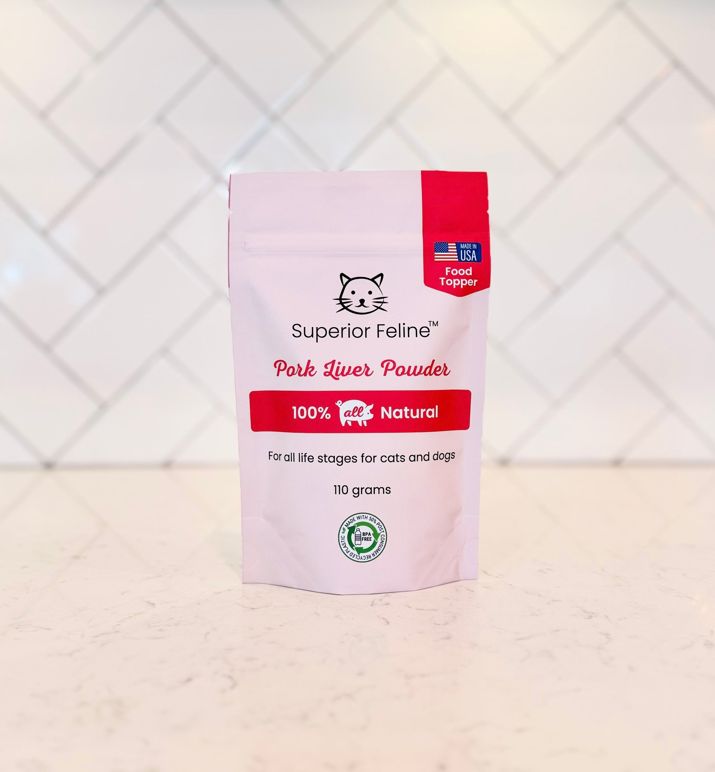 Superior Feline Pork Liver Powder pouch on a white surface with a white geometric patterned wall in the background.