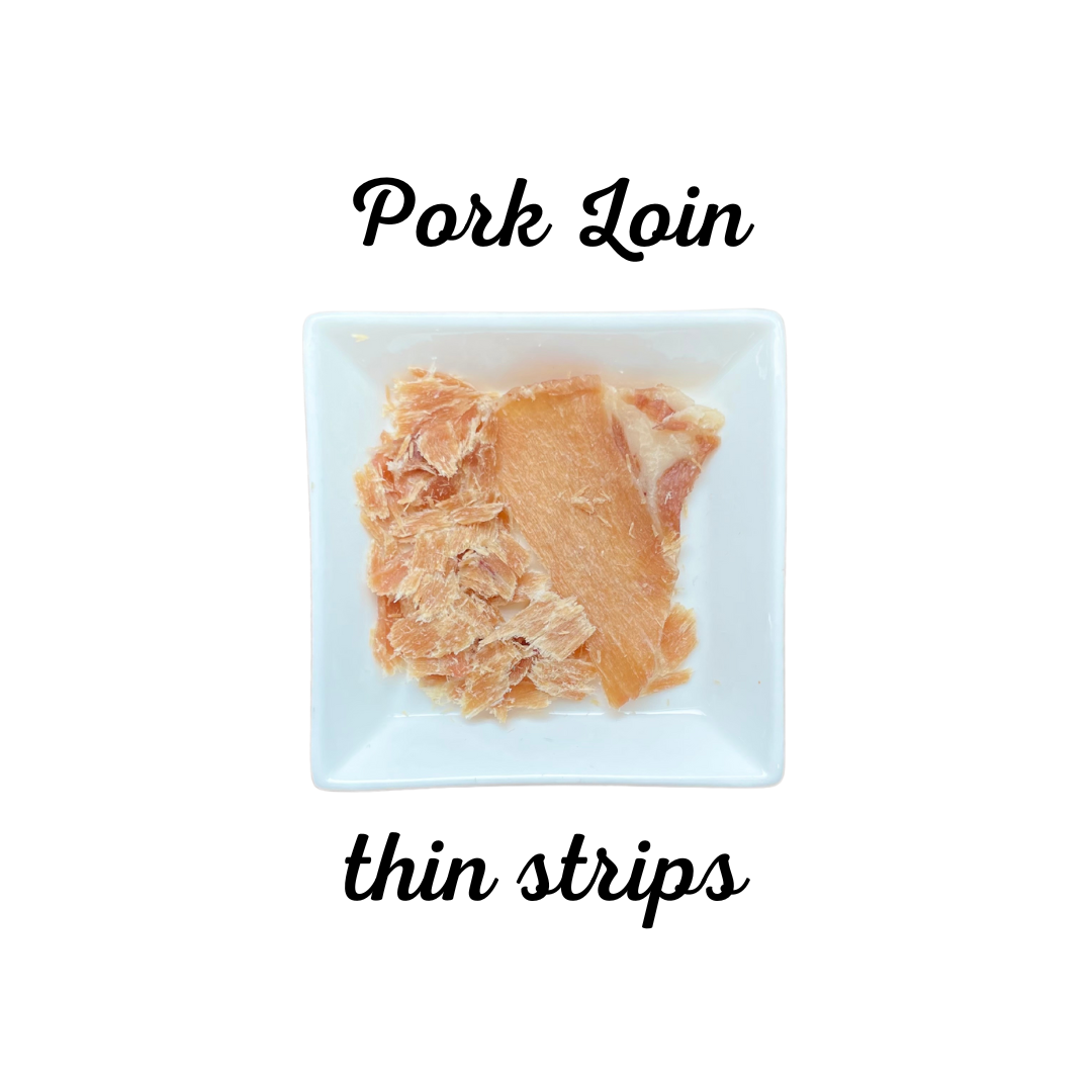 Pork loin thin strips on a white plate with text indicating the type of meat.