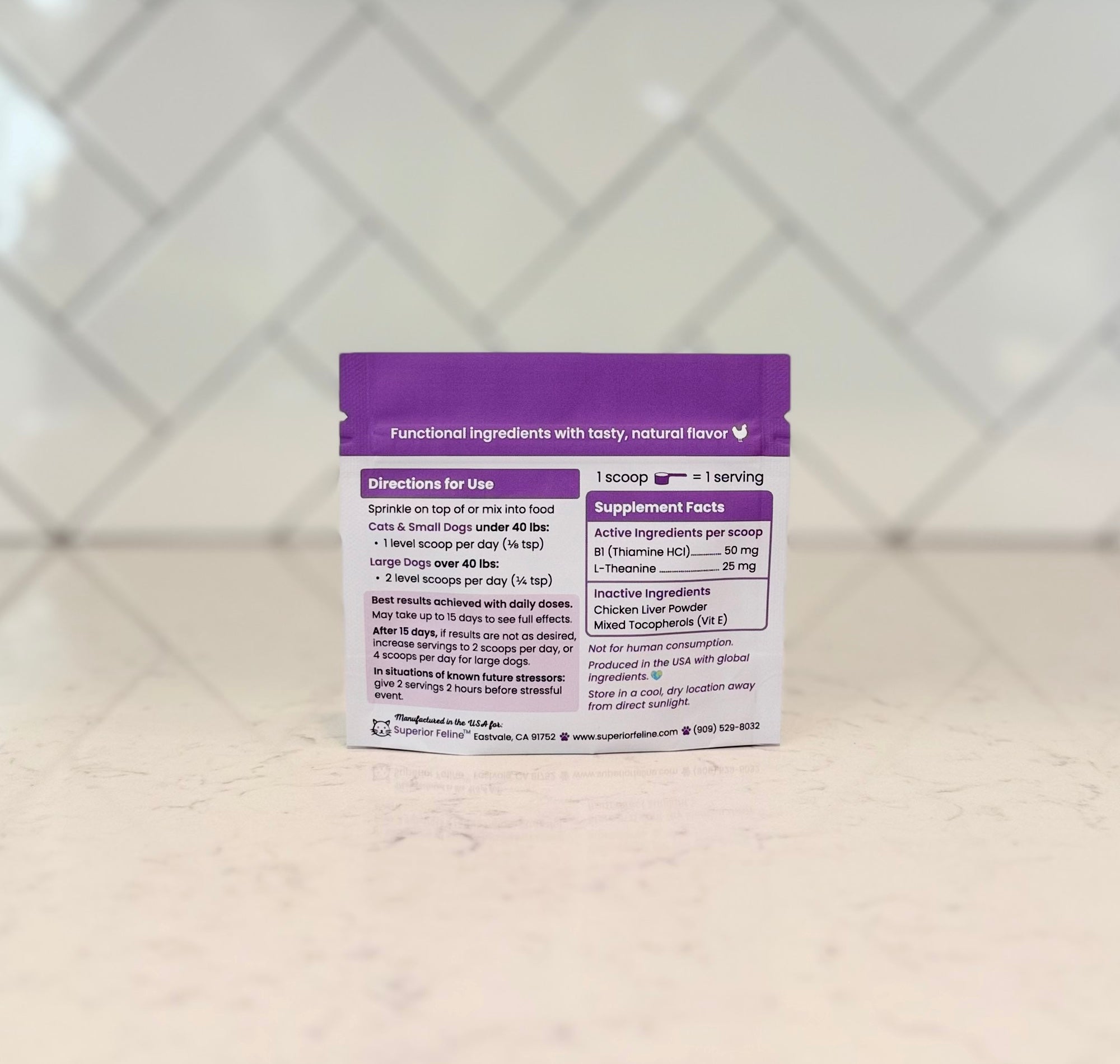 Purple supplement package on a textured surface with a geometric patterned background