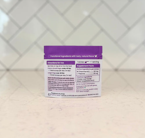 Purple supplement package on a textured surface with a geometric patterned background