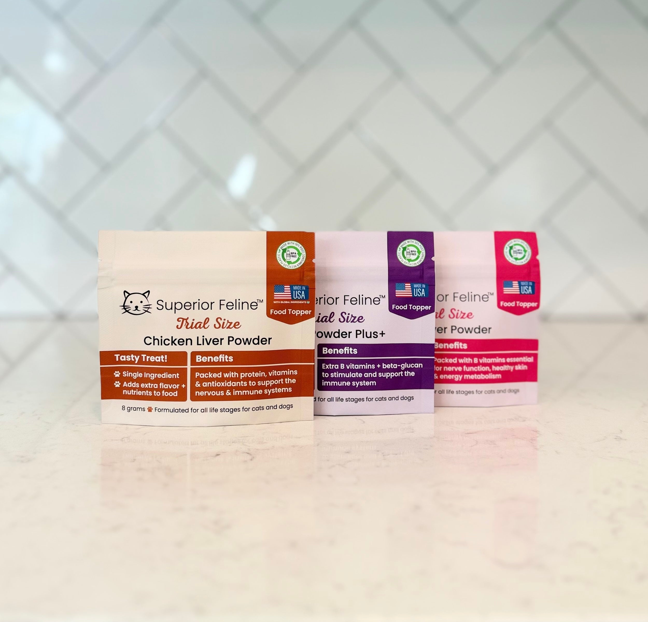 3 small pouches with different flavors of Liver Powder for Cats and Dogs sitting on a kitchen counter