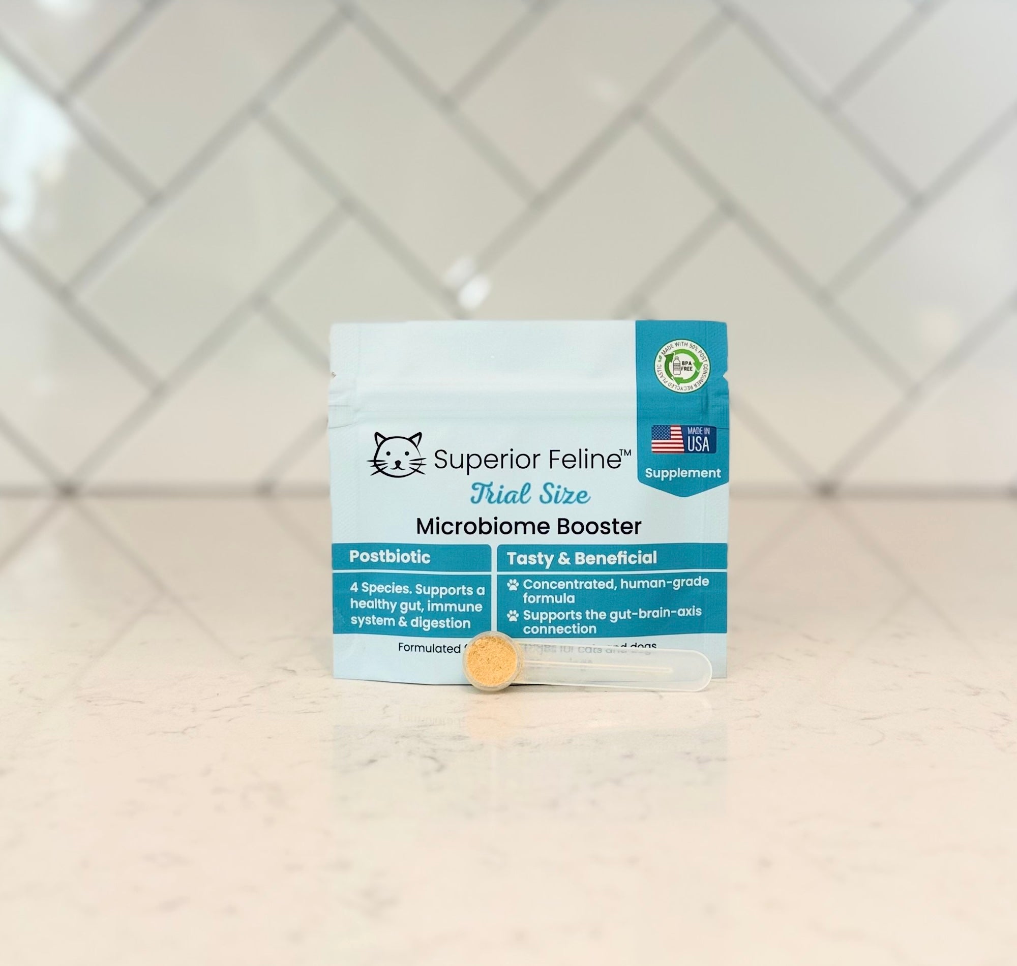 Superior Feline Microbiome Booster with scoop in front on a tiled counter
