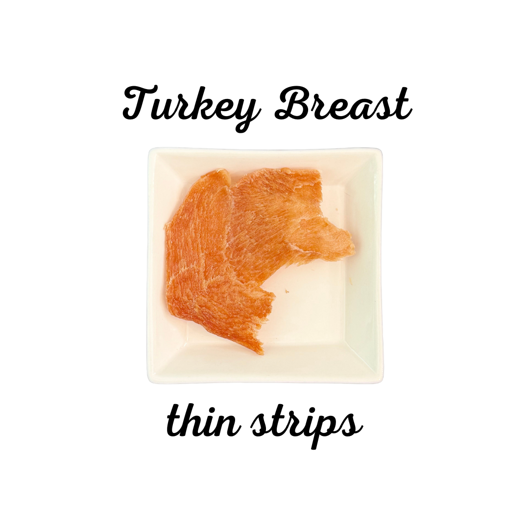 Thin strips of dehydrated turkey breast on a white background with text indicating the type of product.