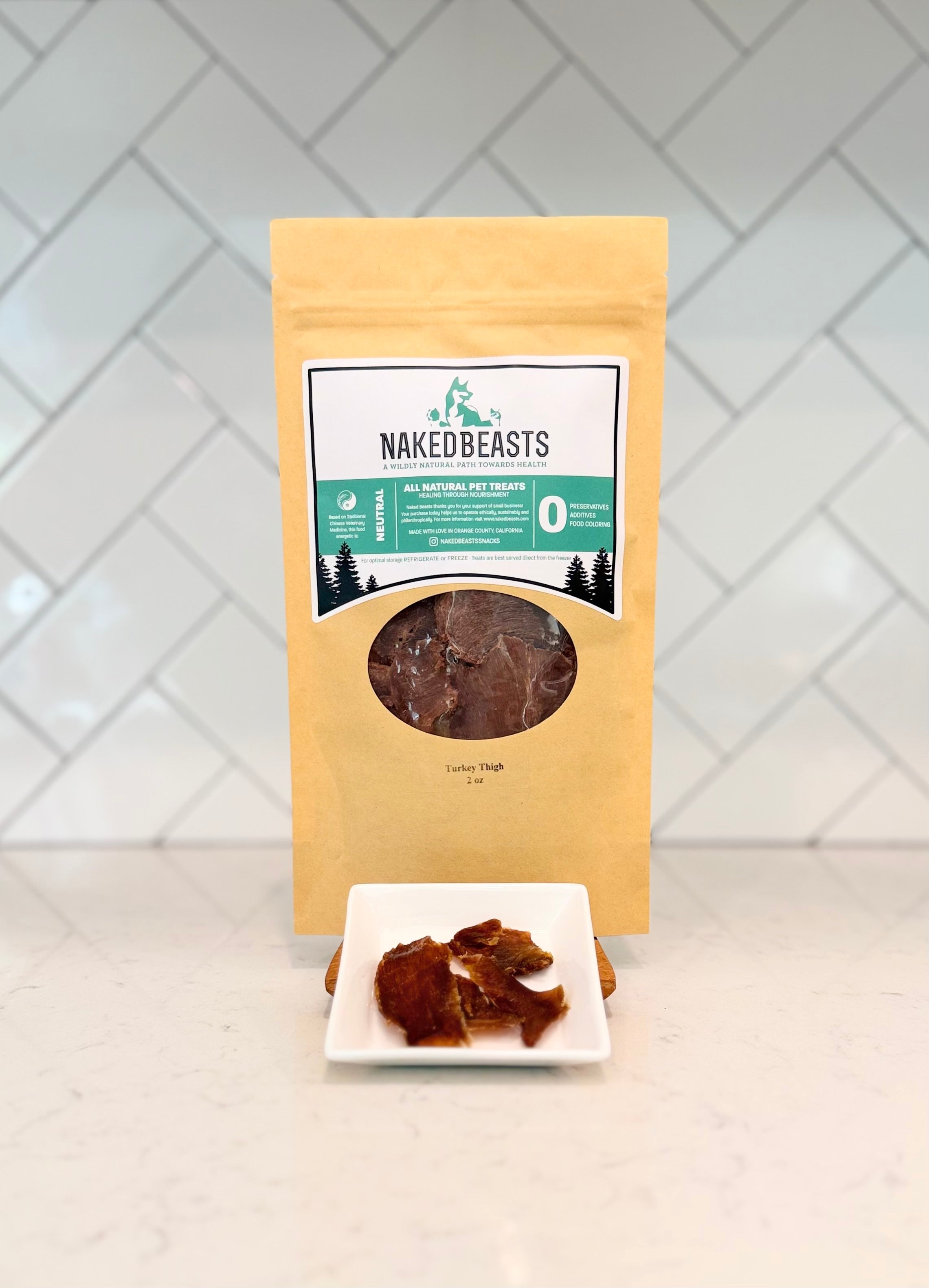 Naked Beasts pet treat package with a sample on a white plate against a tiled wall background