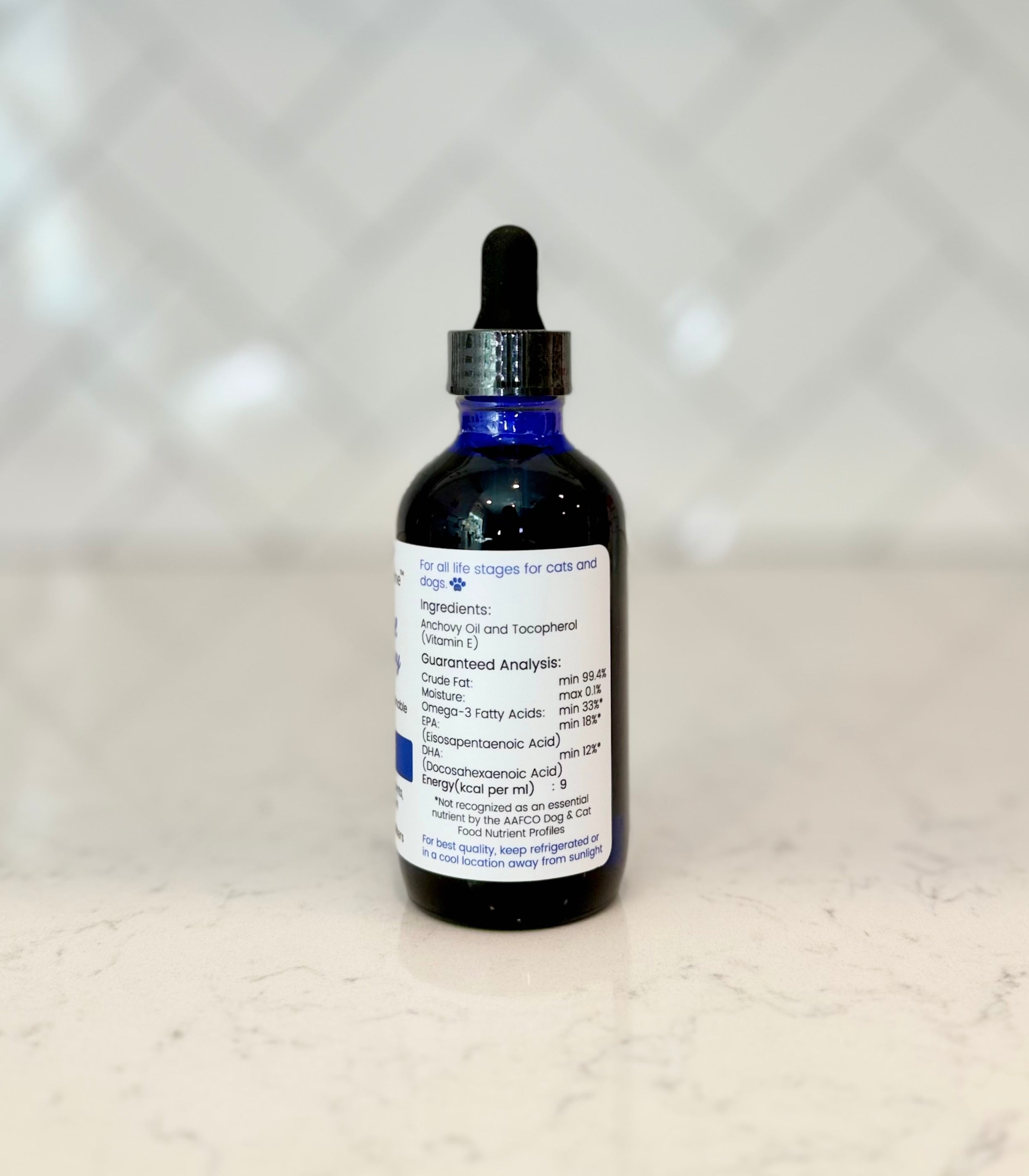 Side view of Superior Feline Wild Anchovy Oil with a label containing text about ingredients and storage